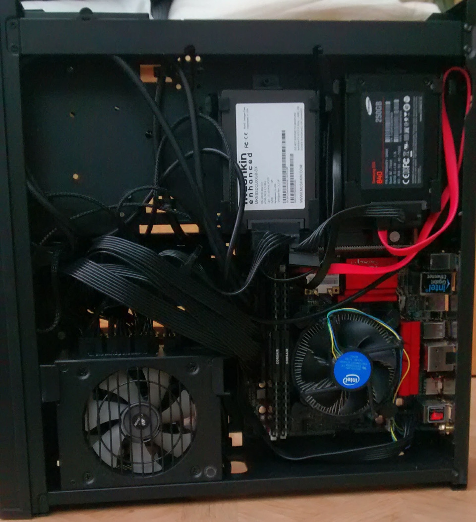 The rats nest of cables on the other side of the case